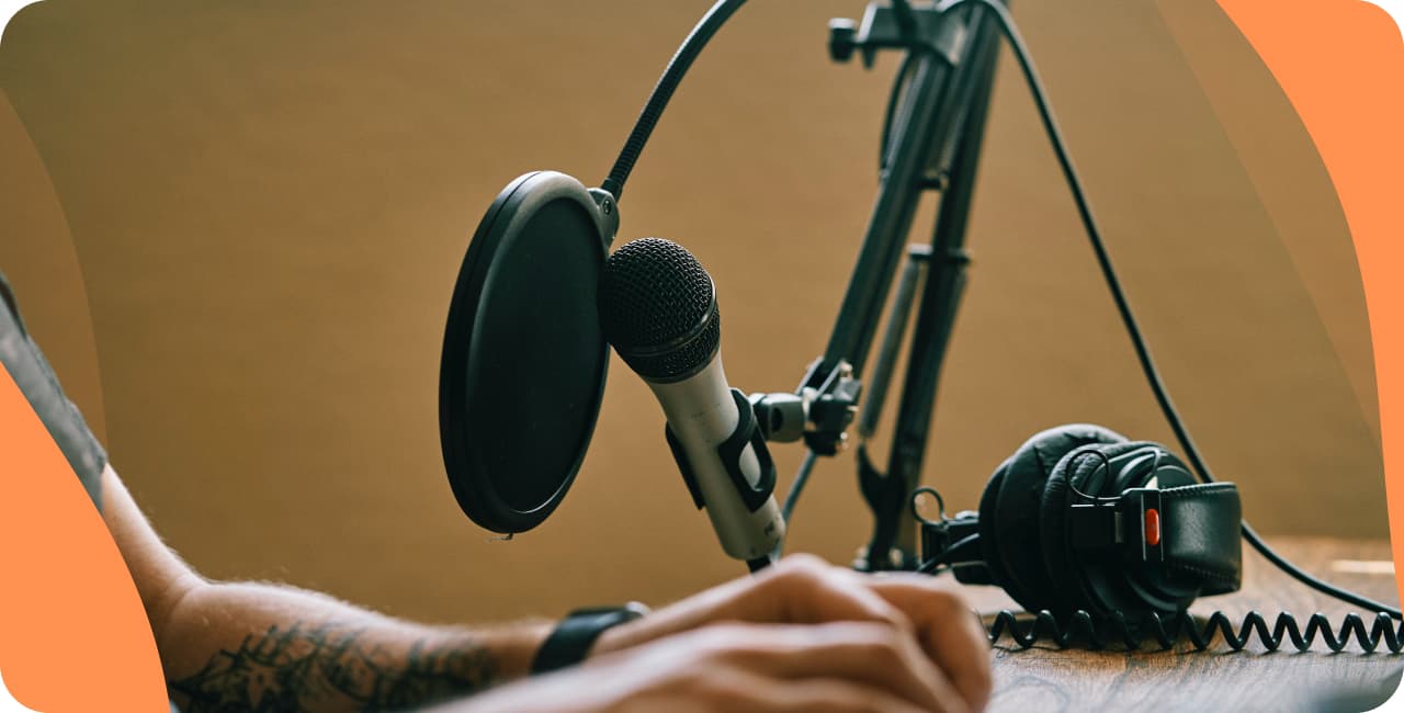 Desk with a radio microphone, pop filter and headphones