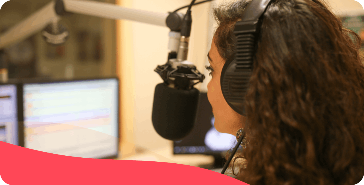 Woman in a radio studio, broadcasting live to listeners on a radio station