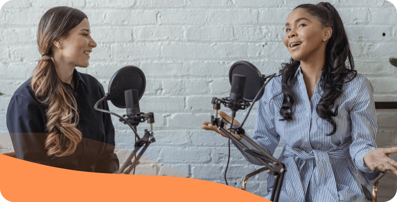 Two women speaking into microphones for a radio broadcast or podcast